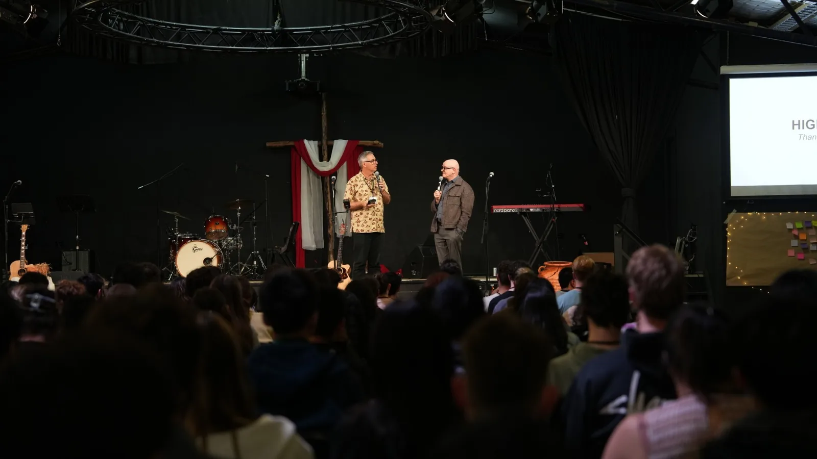 Two speakers talking on stage in the auditorium
